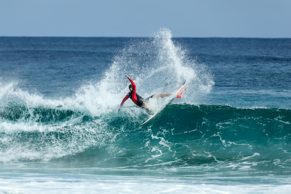 Surfboard performs tail slide